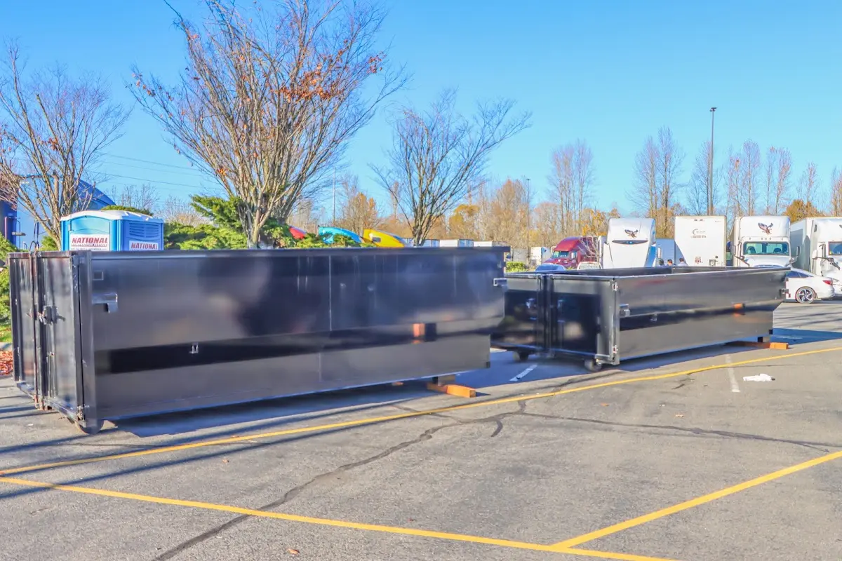 Professional dumpster rental service with roll-off container on residential driveway in Tempe